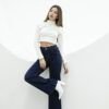 Mujer caminando con jean wide leg azul EDGE, combinando el denim con una blusa blanca para un look casual chic.